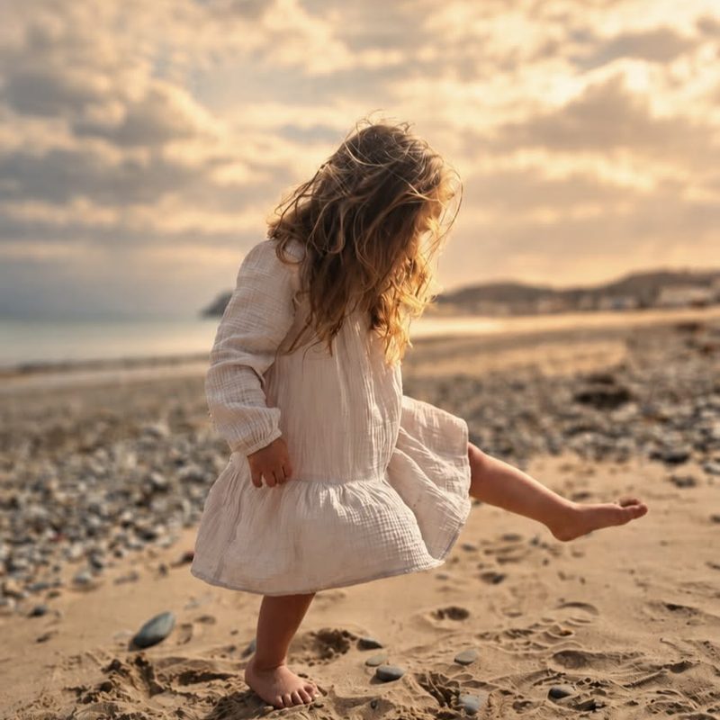Girl dancing barefoot on the beach