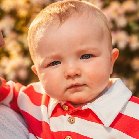 Close-up portrait of a baby in spring sunshine